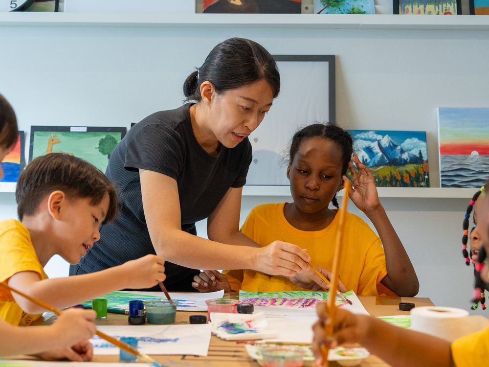 Children painting together at a workshop